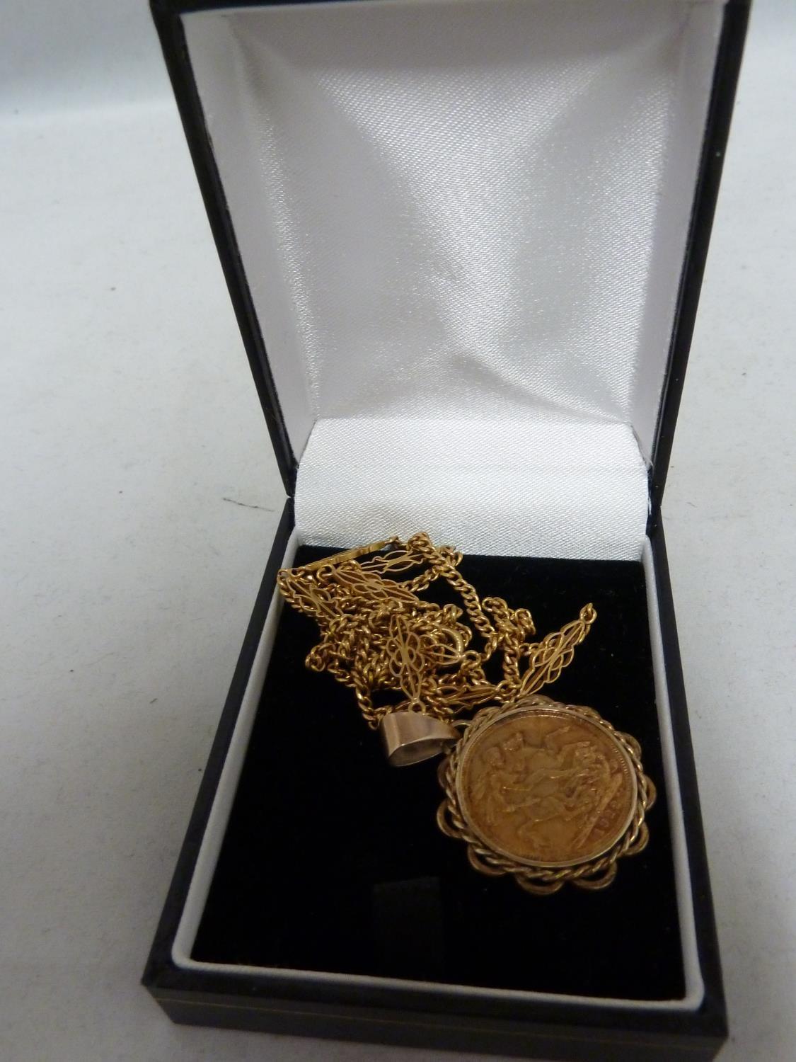 A gold Sovereign coin, dated 1922, mounted as a pendant and with a yellow gold fancy link chain