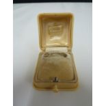 Cartier - a bakelite ivorine ring box, push button fastening, cream silk and velvet lined and