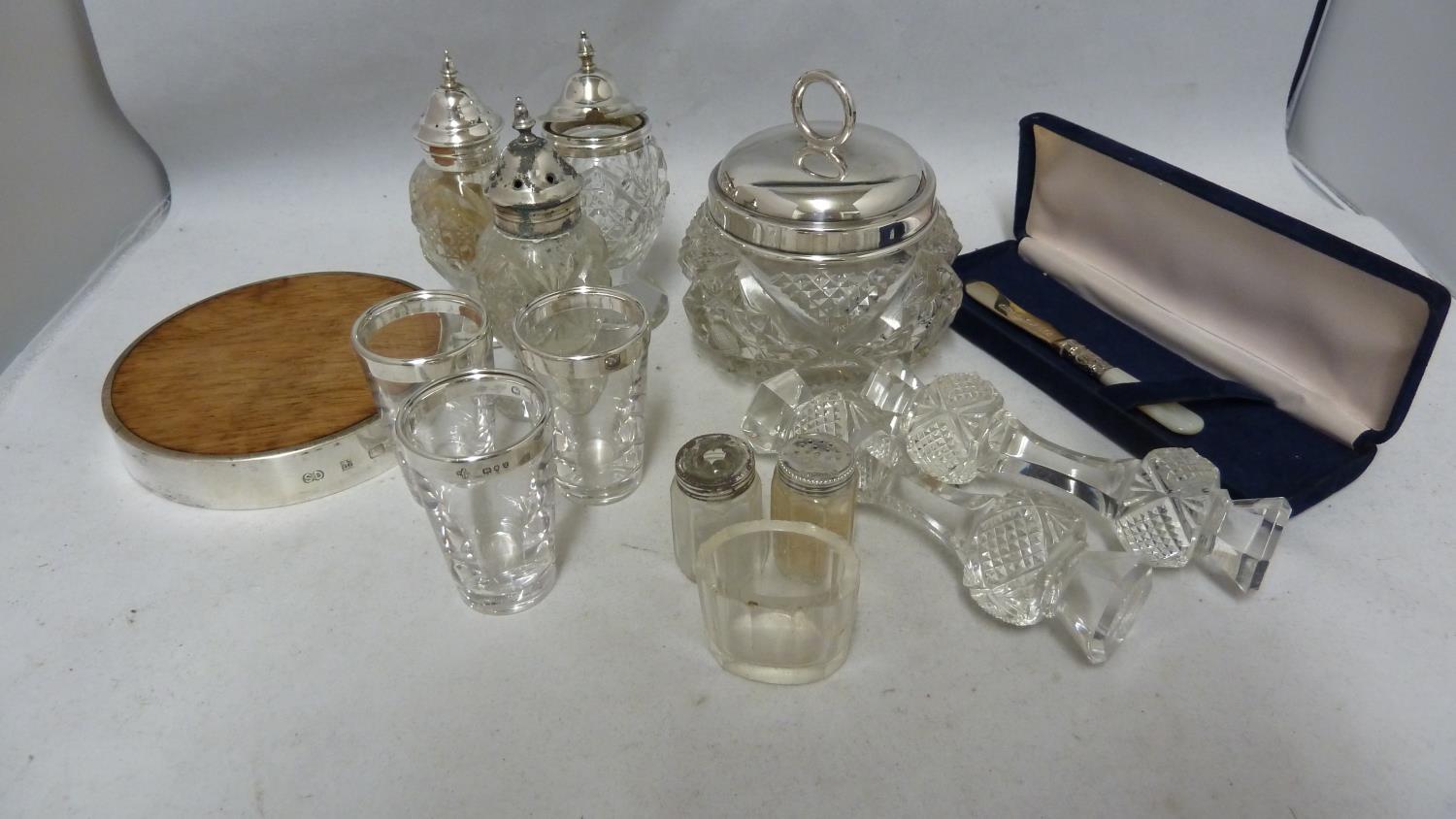 A silver mounted wooden lemon cutting board, circular; and a small size silver bladed butter