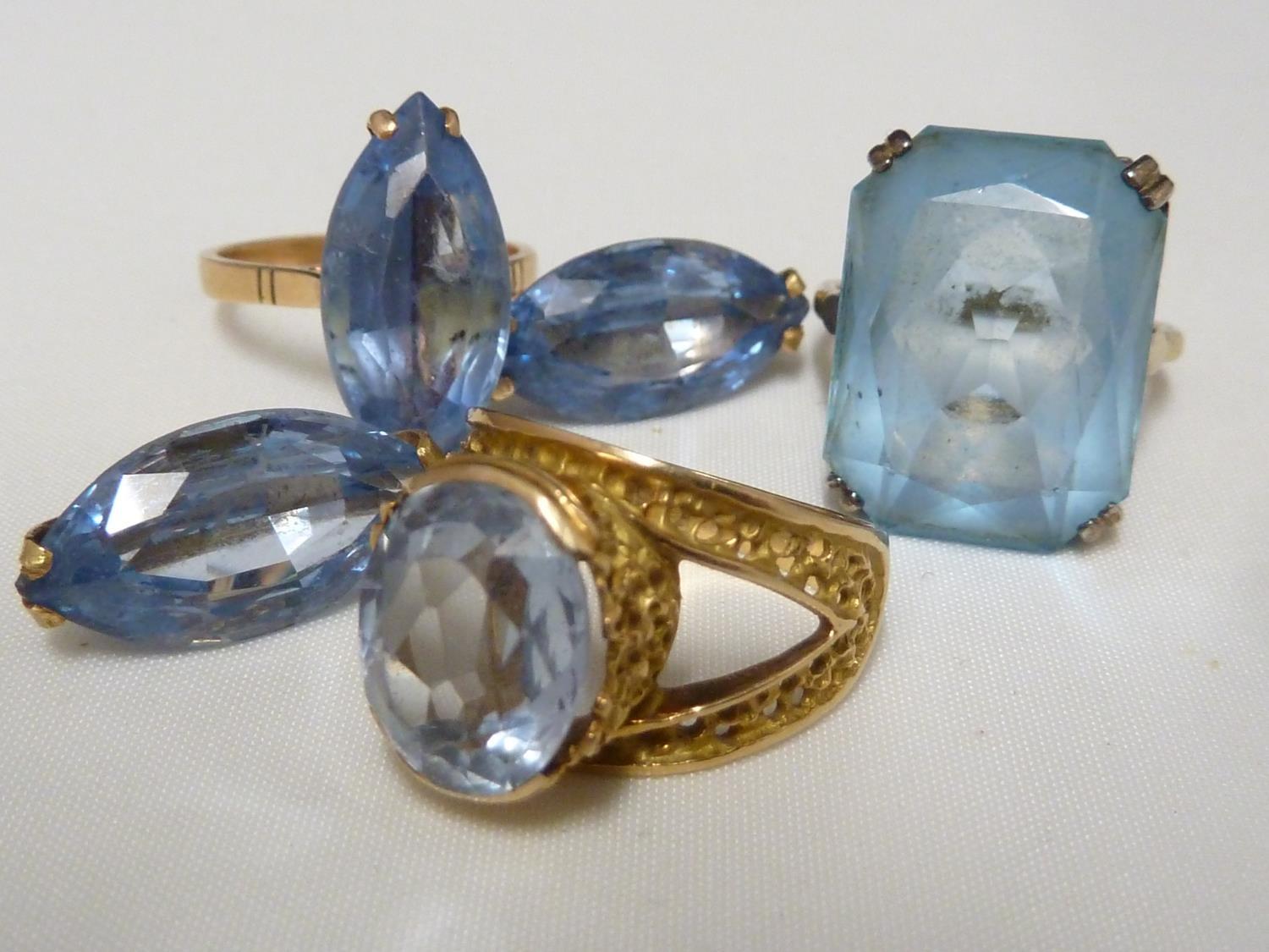 An aquamarine set ring, set in pierced yellow metal, stamped with Arabic marks; a marquise ring