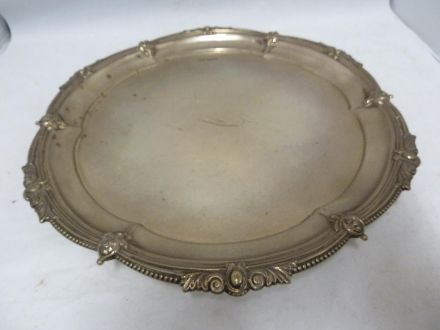 A Walker and Hall silver salver, of shaped circlar form the rim decorated with foliate pendants