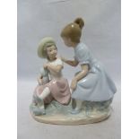 Nao - a porcelain figure group of two girls and a baby, 18.5cm high approx