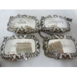 Four silver decanter labels, rectangular with shell and foliate gadrooned frames, marked BRANDY,