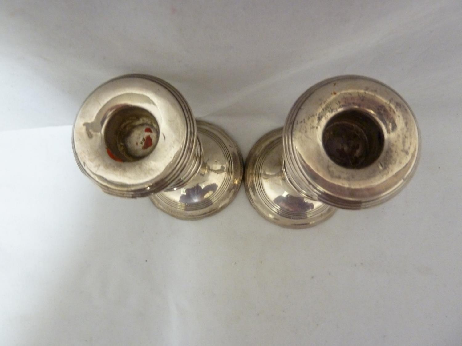 A pair of silver candlesticks, with reeded rims, Birmingham 1955, makers mark B&Co for Broadway & - Image 4 of 9