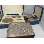 A Victorian style silver mounted dressing table set in fitted cases, the backs repousse decorated