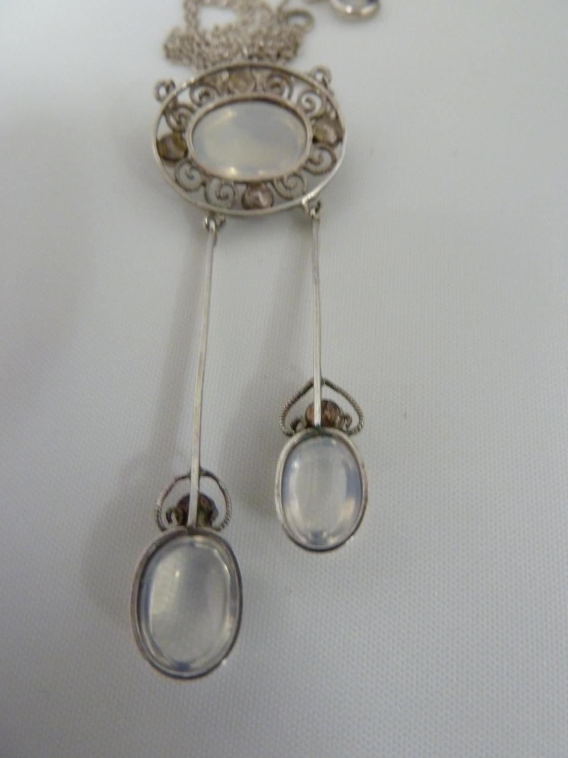 A Belle Epoque pendant and brooch set, the white metal filigree work supporting oval moonstones - Image 7 of 7