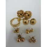 A pair of 9ct yellow gold knot form earrings; and six pairs of yellow metal earrings, 10grms total
