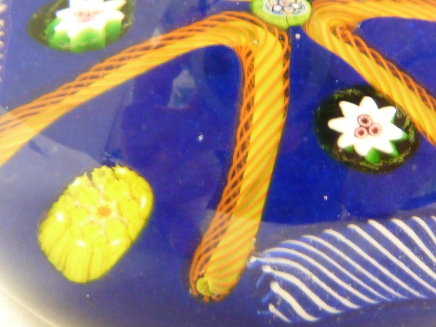 Paul Ysart - a glass paperweight, blue ground, decorated with a star of orange twist canes, 7.5cm - Image 2 of 4