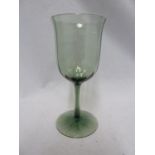 Harry Powell for James Powell & Sons, Whitefriars Limited-a dark green vertical ribbed wine glass,