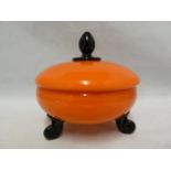 Michael Powolny for Loetz - an orange glass bowl and cover, circular on three black rams horn