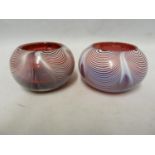 Stevens & Williams - a pair of open table salts, of white feathering on ruby glass body, 8 cm diam