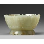 A CHINESE PALE AND RUSSET CARVED JADE 'LOTUS' CENSER