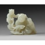 A CHINESE PALE JADE CARVING OF A MAN AND A BOY