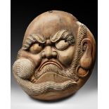 A JAPANESE WOODEN KANBAN DEPICTING AN ANGRY LOOKING ZEN PATRIARCH DARUMA