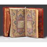 A SMALL RED LEATHER-BOUND QURAN