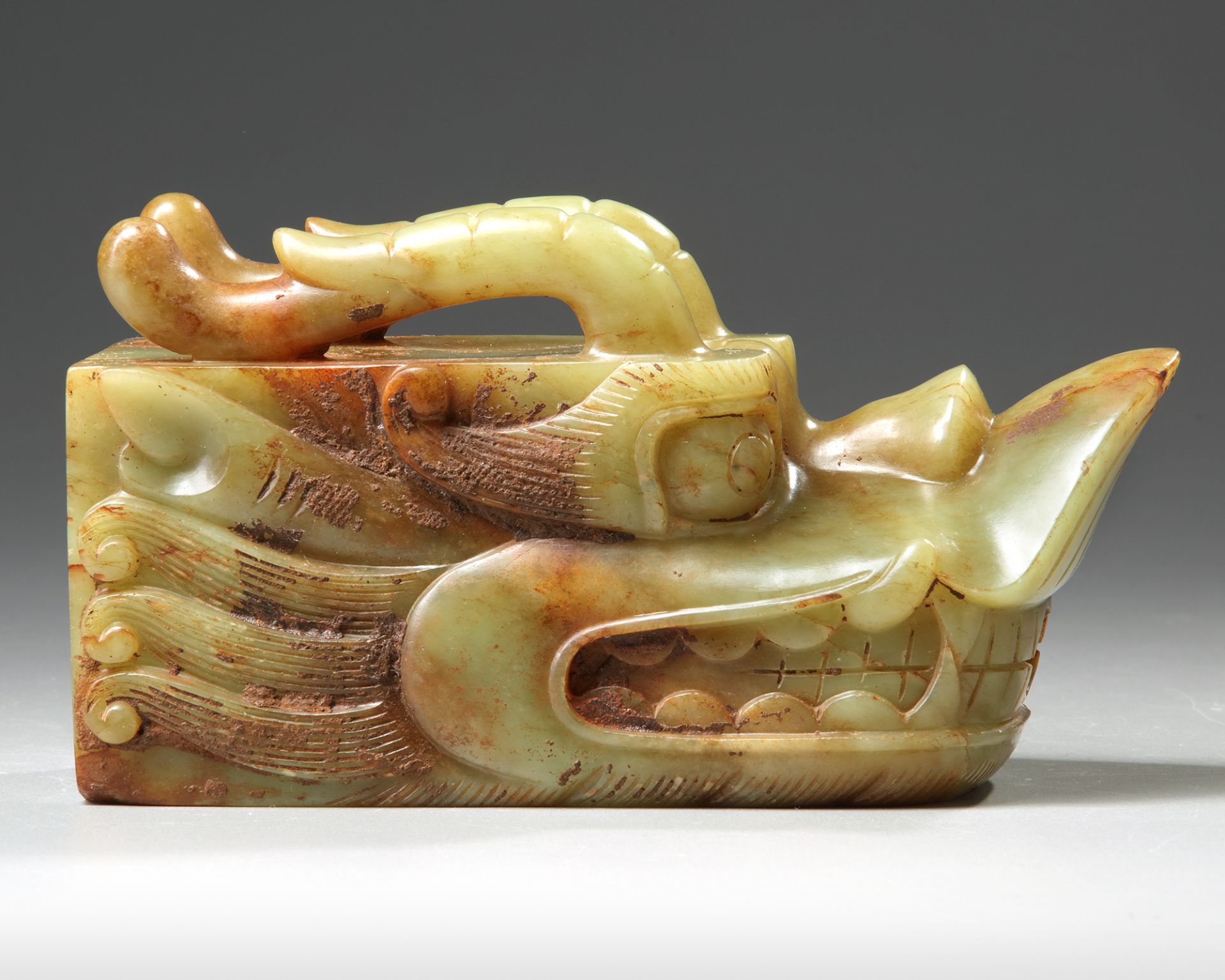 A CHINESE CELADON JADE 'DRAGON-HEAD' SPOUT