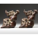 A PAIR OF CHINESE YIXING STONEWARE JUMPING BUDDHIST LIONS