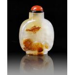 A CHINESE SHADOW AGATE 'BUDDHIST LION' SNUFF BOTTLE