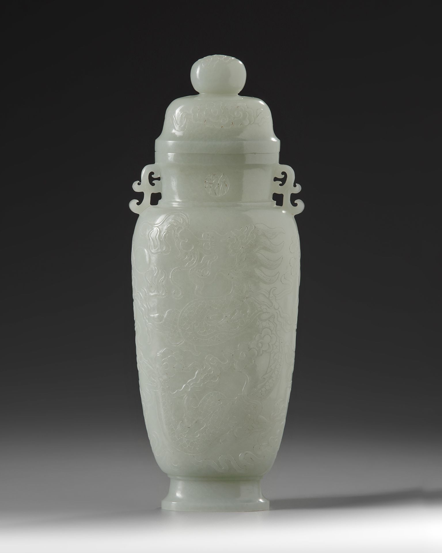 A Chinese pale celadon jade vase and cover