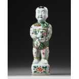 A CHINESE FAMILLE VERTE FIGURE OF A BOY.