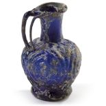 A SMALL BLUE MOULDED GLASS EWER, SYRIA, 10TH CENTURY