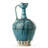 A LARGE RAQQA UNDERGLAZE PAINTED POTTERY EWER, SYRIA, 12TH-13TH CENTURY