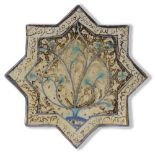 A STAR-SHAPED KASHAN TILE, PERSIA, 13TH-14TH CENTURY