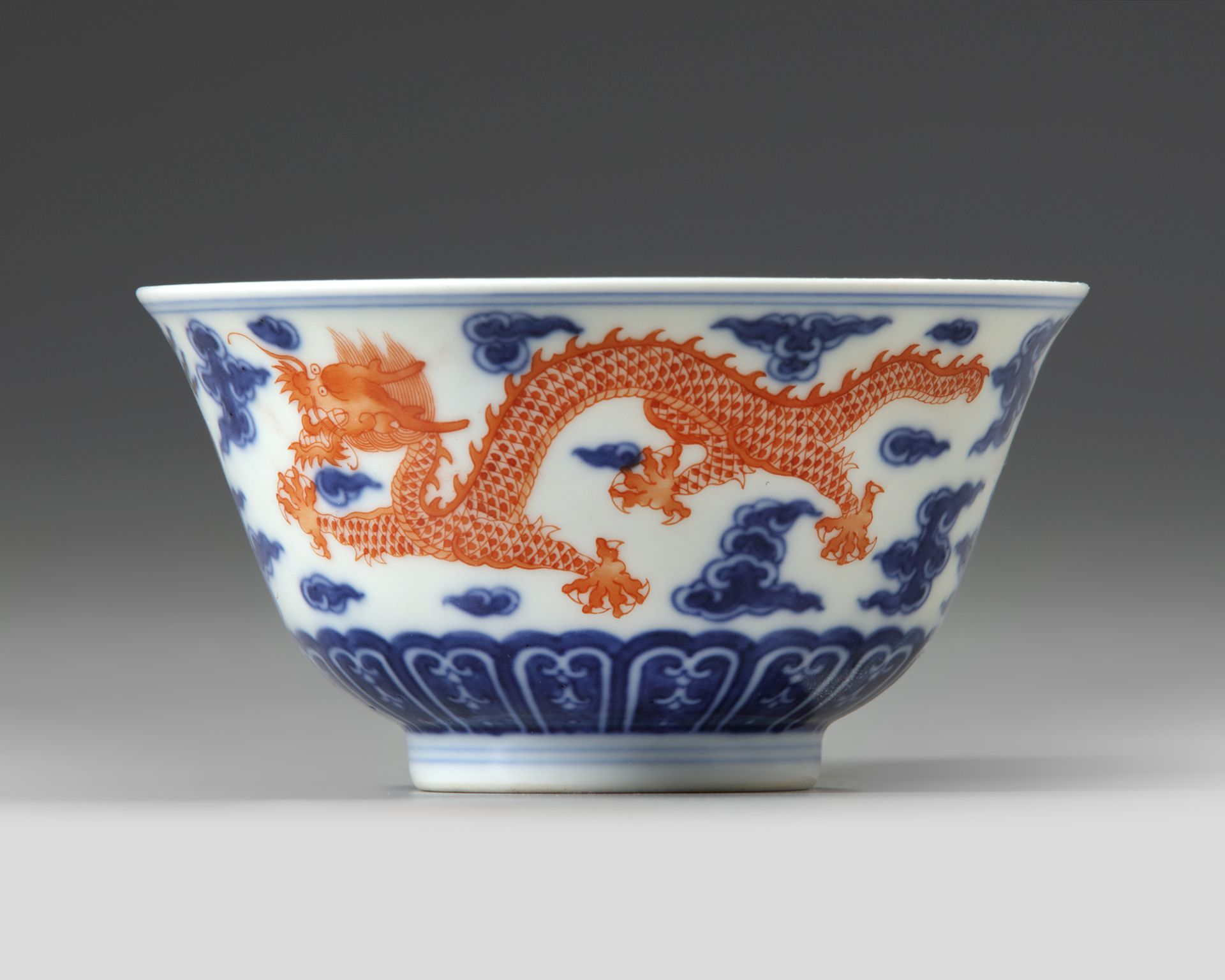 A CHINESE BLUE AND WHITE IRON-RED DECORATED 'DRAGON' BOWL, SIX-CHARACTER JIAQING MARK AND OF THE PER