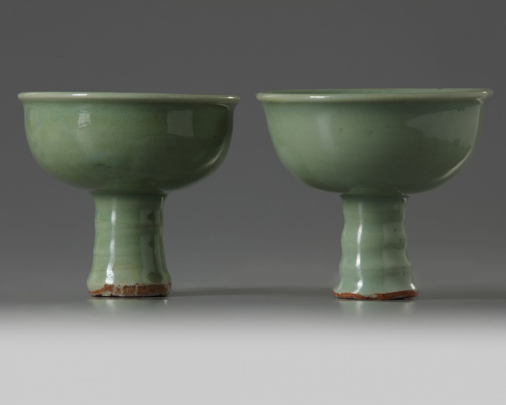 A SIMILAR PAIR OF CHINESE CELADON GLAZED STEMCUPS, LATE YUAN, EARLY MING DYNASTY, 14TH CENTURY