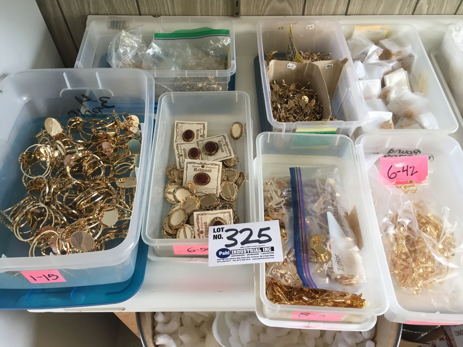 7 Boxes of assorted Gold colored clips, bracelets, pins etc.