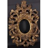 18th Century Italian School. A Carved Giltwood Florentine Frame, Oval, rebate 6.5” x 5” (overall