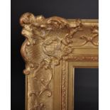 20th Century French School. A Gilt Composition Frame, with swept centres and corners, rebate 16” x