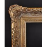 20th Century Continental School. A Gilt Composition Frame, with swept centres and corners rebate