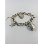 Silver Hall marked chain bracelet with charms. 20cms diameter 45 grams.