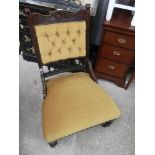 Victorian gentlemans button back chair with yellow upholstery.