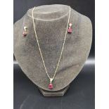 9ct gold diamond and red stone earrings and pendant together with 9ct gold chain.