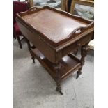 19th century folding table with drop leaf in carved design.