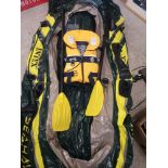 Large river rafting rubber dinghy with paddles and jacket.
