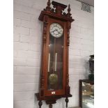 Large victorian wall clock with carved top.