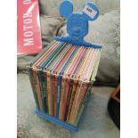 Collection of Walt Disney books with mickey mouse stand.