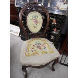 19th century carved back chair with flower design upholstery .