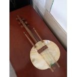African musical instrument with hide, having pokerwork decor.