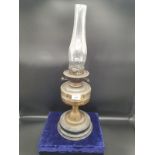 Antique oil lamp with glass shade.