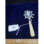 Silver bone handled baby's rattle with cameo centre.