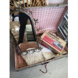 Vintage trunk containing rugs and mirror.