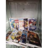 Shelf of ninetendo wii games.