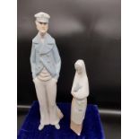 Lladro sailor figure together with nao girl figure holding rabbit.