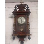 Victorian wall clock with carved top and brass Eagle mascot comes with pendulum etc. Working order.