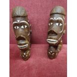 Pair of African busts with mother of pearl inlays.