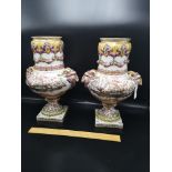Pair of mid 1800s porcelain vases with rams head handles.